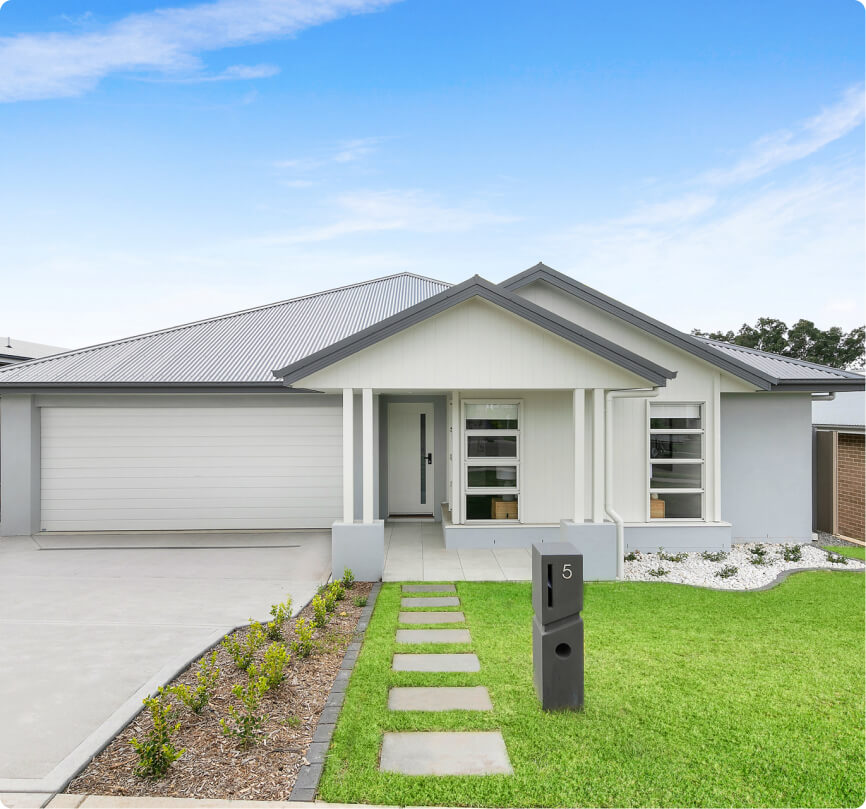Modern single-story house with white exterior and manicured front lawn
